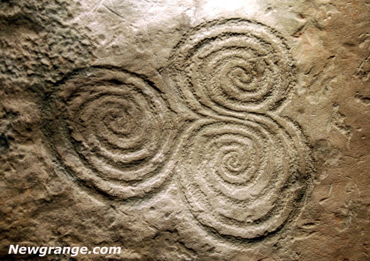 Triple spiral stone carving detail.