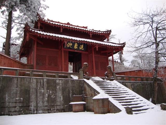 A red building with steps leading up to it.